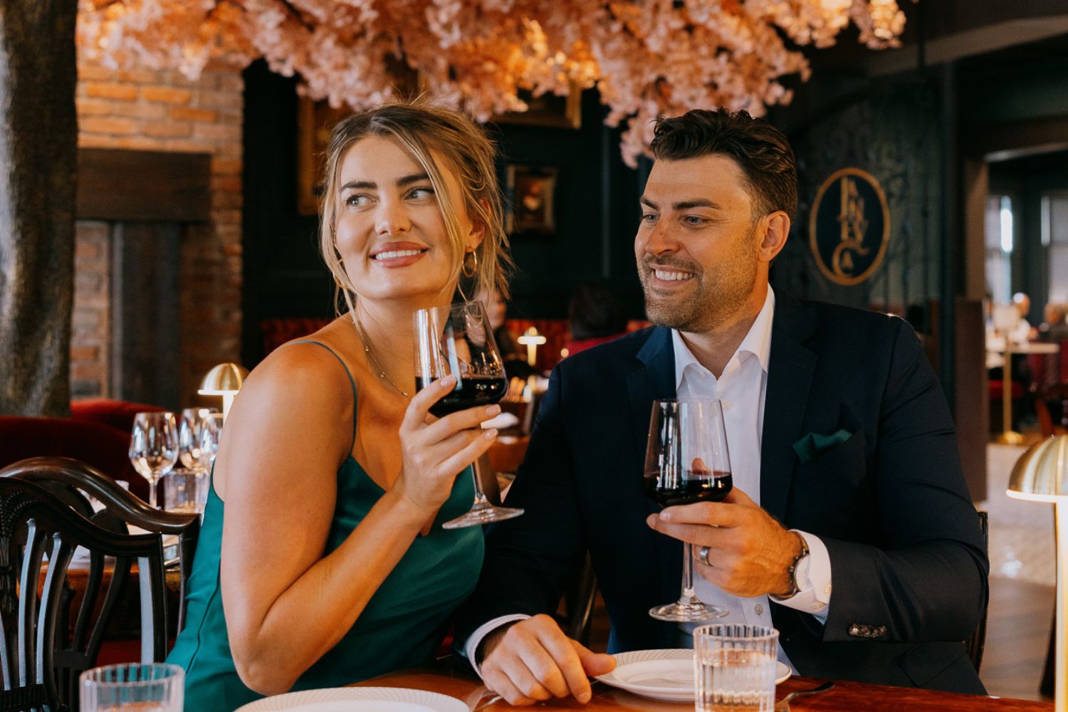 Elegant dining scene with a couple enjoying wine at Janevca Restaurant for the Rosemead New Year’s Eve Soirée.